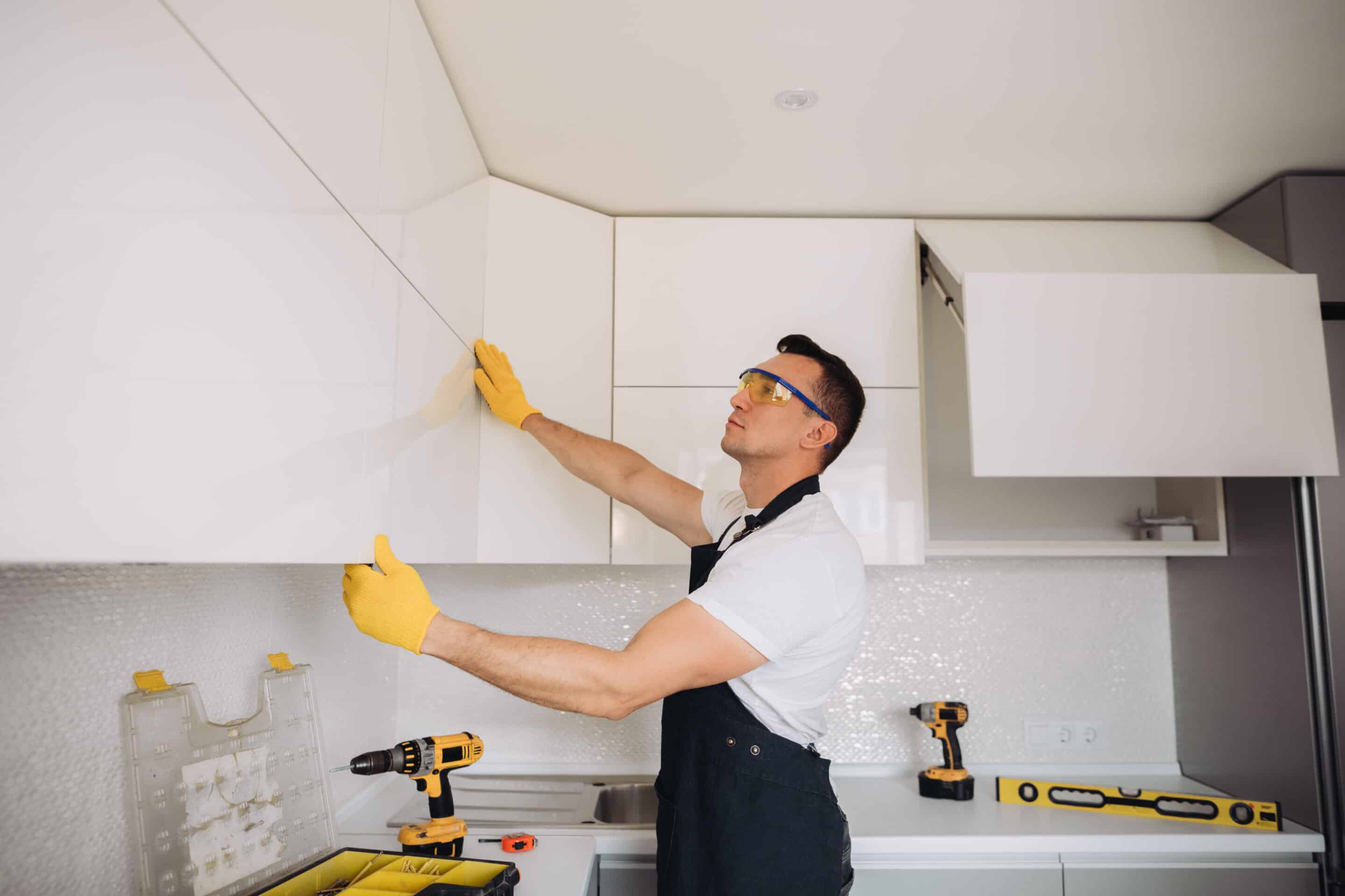 Kitchen remodeler installing cabinets during a North Texas remodel