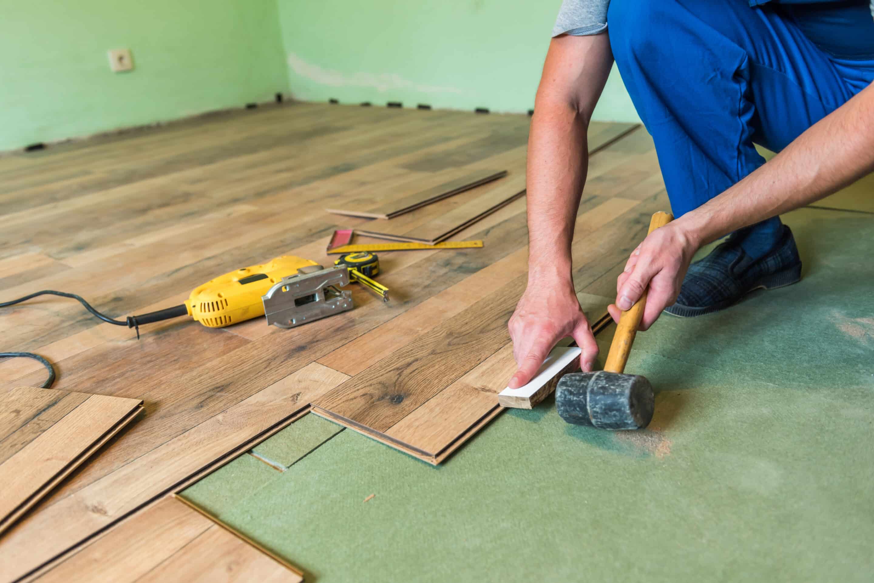 man installing laminate flooring in a home 2026 03 19 02 46 18 utc scaled Flooring Installation